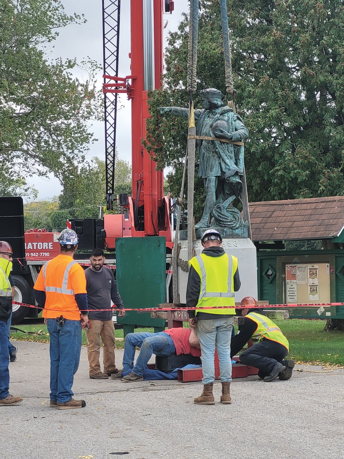 COLUMBUS BY CRANE: The Christopher Columbus statue that stood in Providence for 130 years has been erected on a cement pedestal on the island in the center of Johnston’s War Memorial Park pond. The mayor has planned a Columbus Day unveiling event.